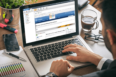 person at desk, using laptop