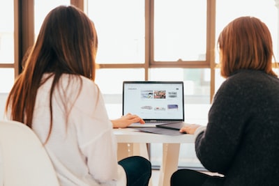 2 people looking at a laptop